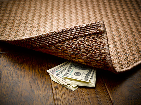 Money hidden under rug
