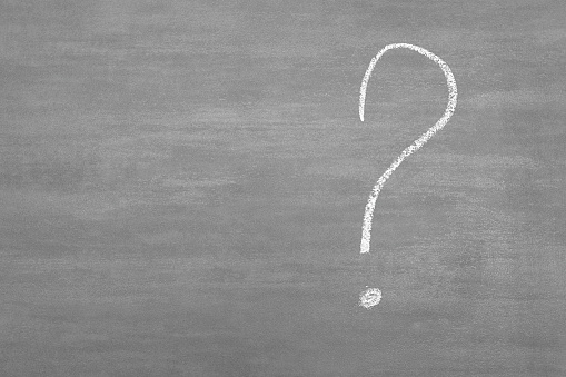 Close-Up Of Question Mark On Blackboard