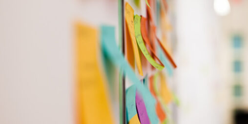 Multicolored sticky notes on whiteboard