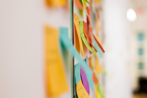 Multicolored sticky notes on whiteboard